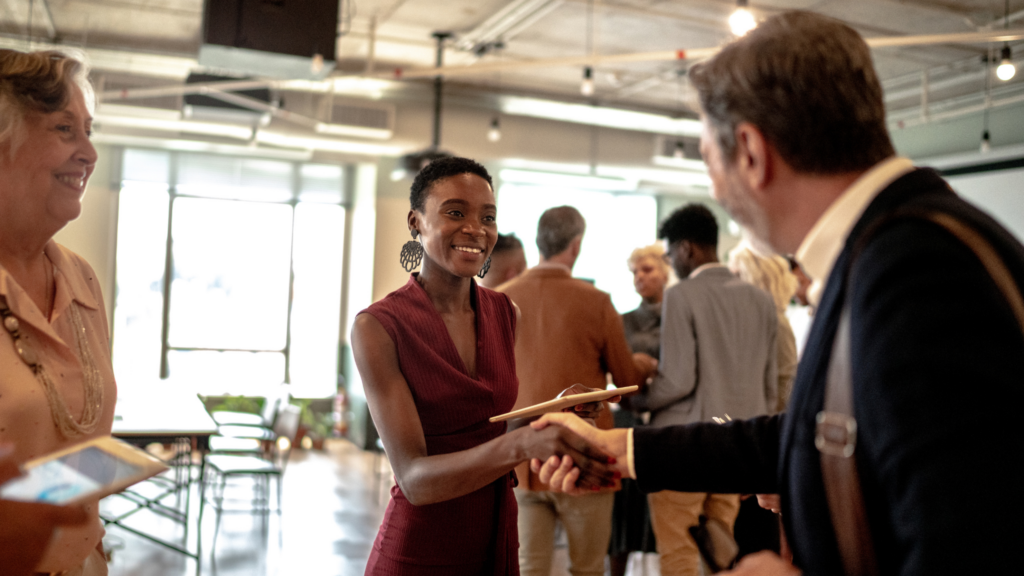 Professionals shaking hands and meeting at an event